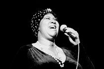 A black and white photo of Aretha Franklin singing