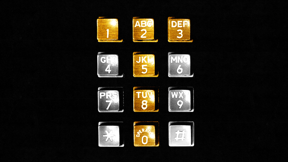 A phone dial with the buttons creating a T colored gold and the others colored silver, with a black background