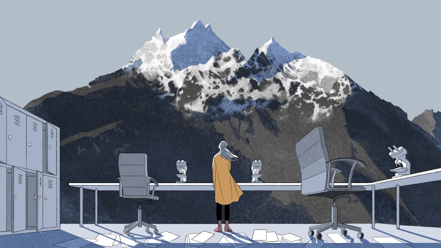 A woman stands in a laboratory with no walls and gazes at a glacier on a mountain.