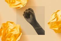 A hand makes a fist in the air