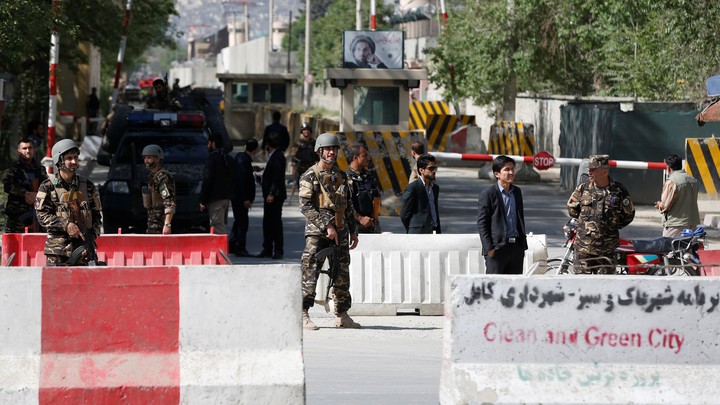 Afghan security next to road barriers