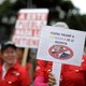 Venezuelan protesters carry a sign against President Trump