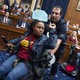 A protester in a motorized chair is pushed out of a House committee room.