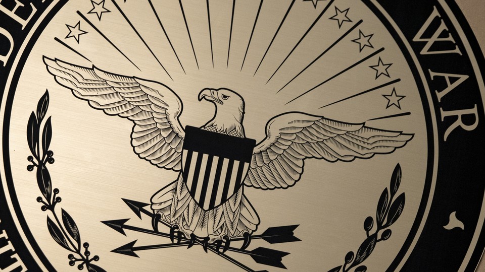 Crop of an official seal with an eagle holding arrows with the word "War" showing.