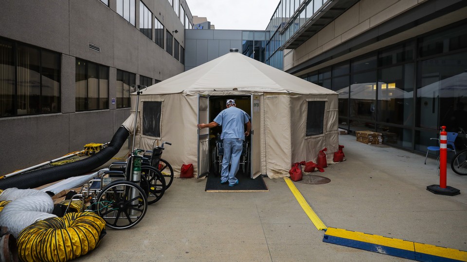 A doctor in front of a makeshift medical tent