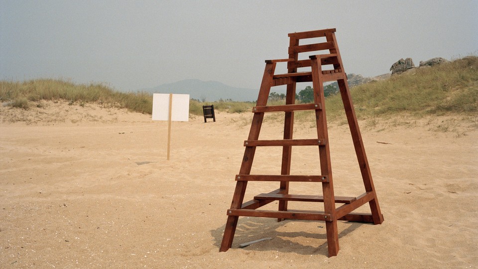 Photo of an empty lifeguard chair on a beach