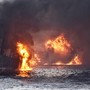 An oil tanker engulfed in flame