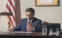 Photo of Speaker Mike Johnson at his office desk talking on the phone
