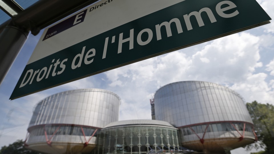 A board reads "Human rights" in front of the European Court of Human Rights in Strasbourg