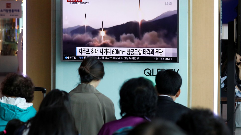 People at a railway station in Seoul, South Korea, watch a TV news report about North Korea's missile launch in April 2017.