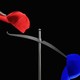 A hand placing a red hat on a scale