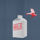 An image of a carton of milk with a bird flying above it