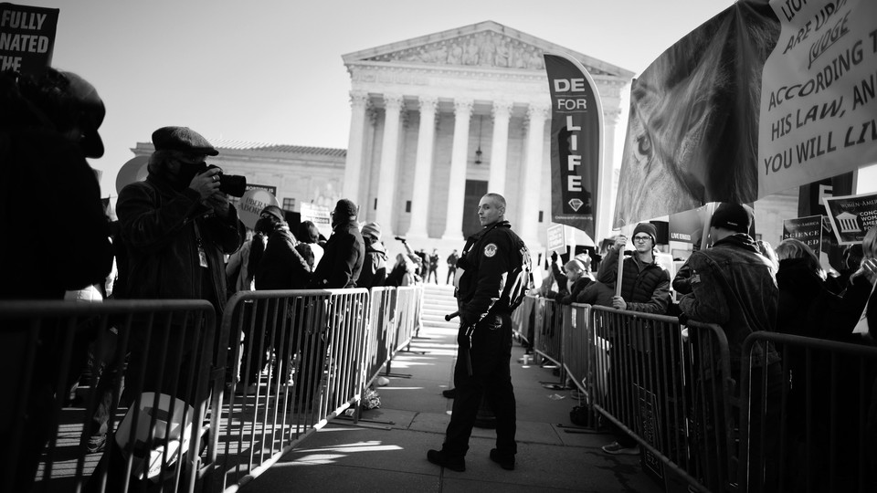 Police use metal barricades to keep protesters, demonstrators and activists apart in front of the U.S. Supreme Court