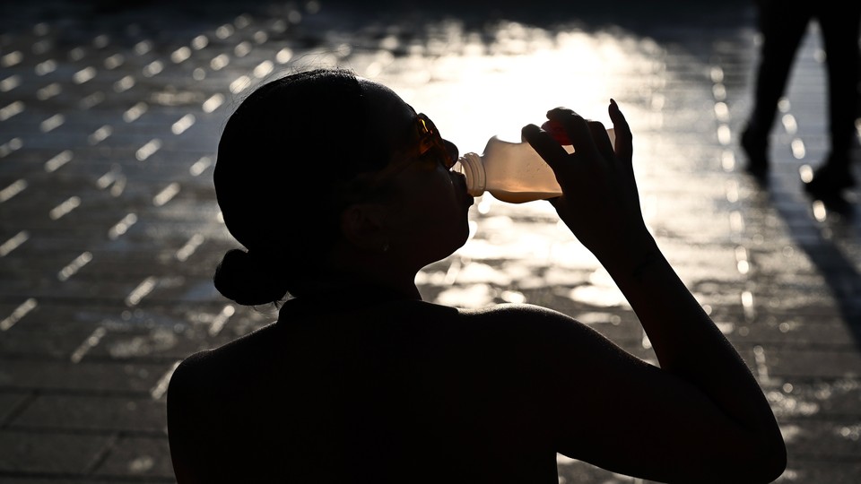 a person downs a hydrating drink