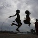 Two children play jumprope. 