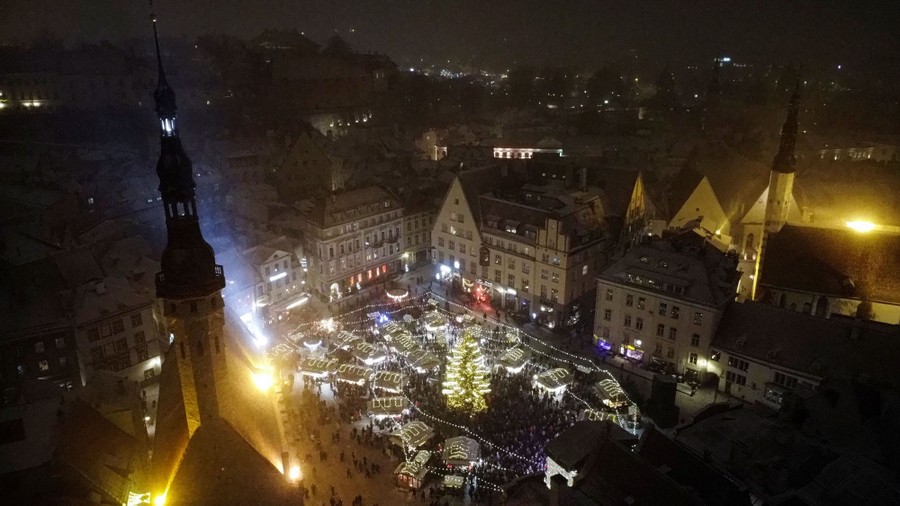An elevated night view of a Christmas market in a European city