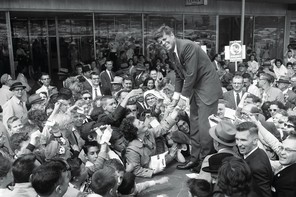 A black and white photograph of JFK campaigning at a Baltimore shopping center in the spring of 1960.