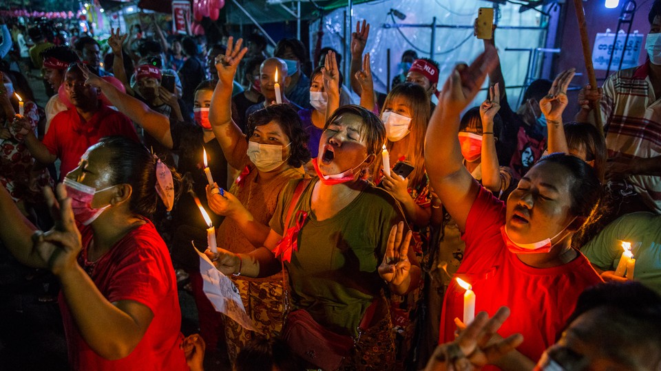 People march in a street in Yangon