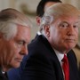 President Donald Trump sits next to Secretary of State Rex Tillerson the day after he ordered a strike on Syria.