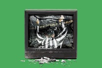 A smashed TV with a referee in its reflection