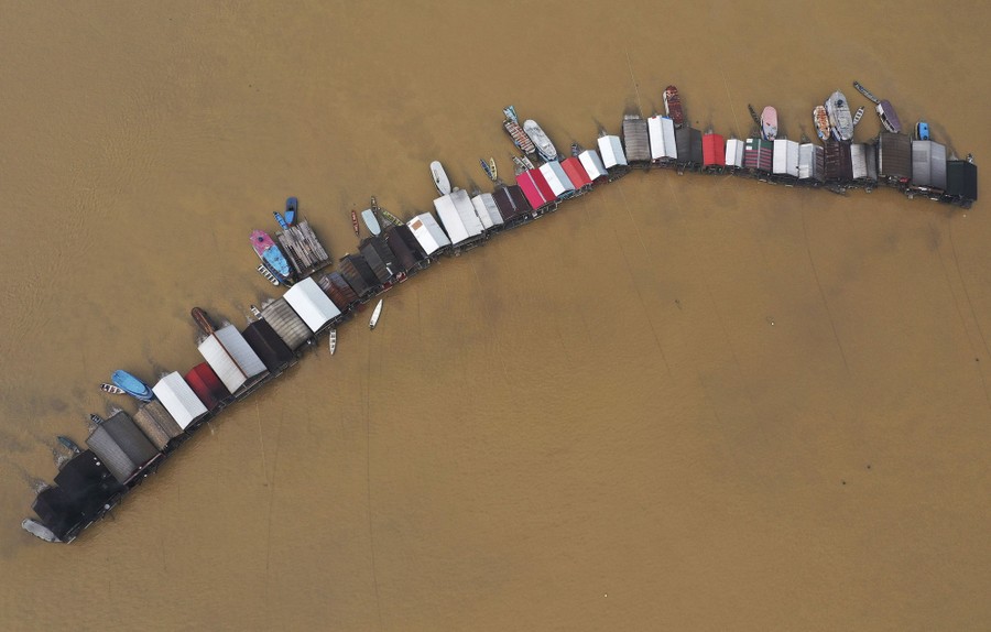 An aerial view of dozens of floating barges