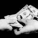 Image of two people exchanging money.