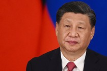 Close-up of Xi Jinping against a red-and-blue field