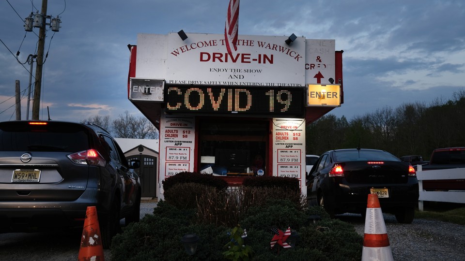 People arrive for a movie at the Warwick Drive-In on the first evening that the theater was allowed to reopen, May 15, 2020 in Warwick, New York.