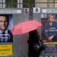 A woman walks past posters of presidential candidates Emmanuel Macron and Marine Le Pen in Paris, France on April 28, 2017.