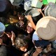 Palestinians scramble for aid at a food-distribution point.