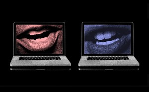 An image of two laptops, with images of speaking mouths on the screens