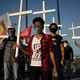 Crowd holding crosses at a protest