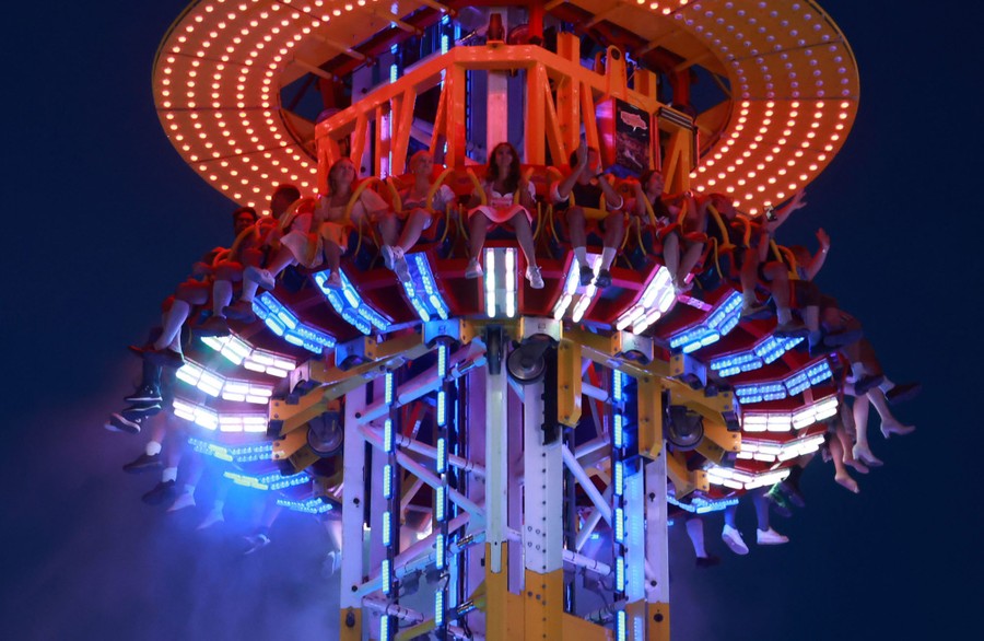 Festivalgoers are lifted high on a carnival ride.