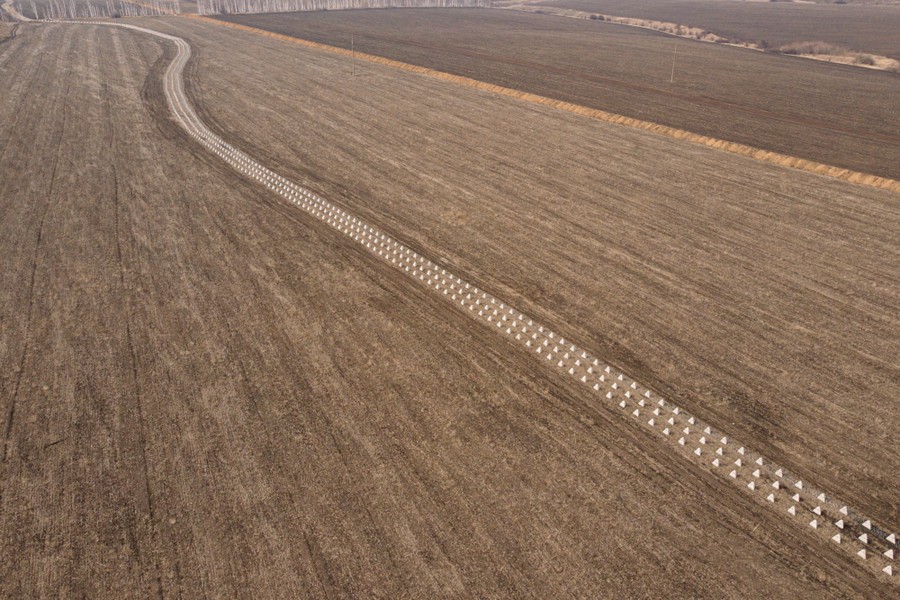 An aerial view of a field with a long line of "dragon's teeth," small concrete pyramids designed to be obstacles to vehicles