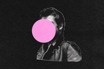 A man in a leather jacket with a pink bubble in front of his face