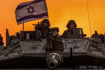 Israeli soldiers on a tank near the Israel-Gaza border