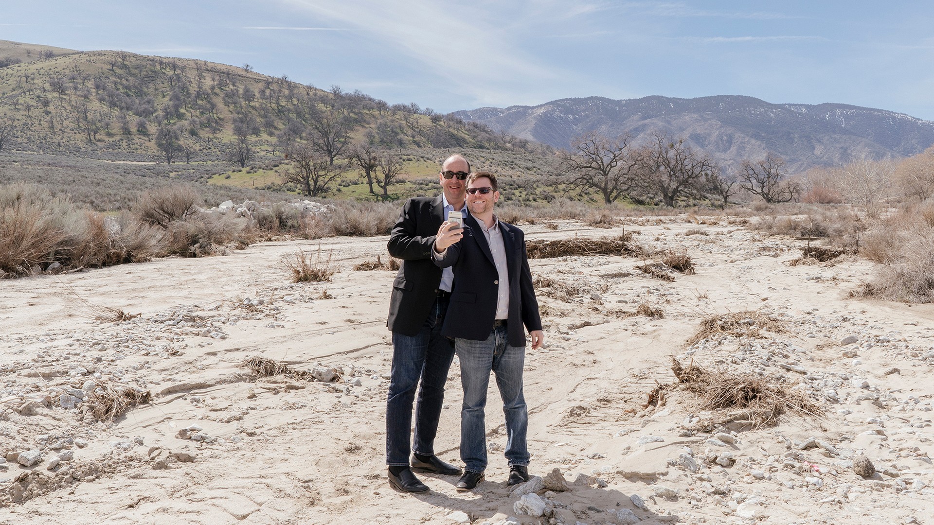Steven Davidoff Solomon and Frank Partnoy pose for a selfie on the rocky soil of Tejon Ranch