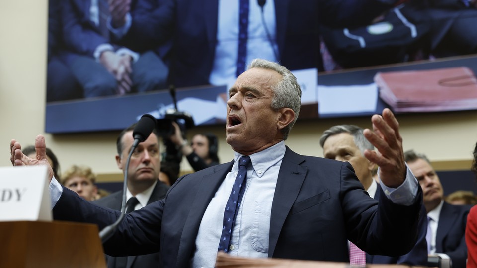 RFK Jr. gestures behind a desk