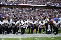 Baltimore Ravens players, including former player Ray Lewis, kneel during the playing of the U.S. national anthem before an NFL football game against the Jacksonville Jaguars at Wembley Stadium in London, Sept. 24.