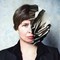 Photo-illustration with a photo of the author and half of her head replaced by torn, layered paper in a sculptural shape