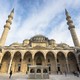 Tourists explore the courtyard of Suleymaniye Mosque in Istanbul.