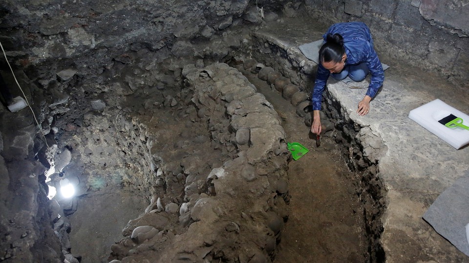 Lorena Vazquez, an archaeologist from the National Institute of Anthropology and History (INAH), works at a site where more than 650 skulls caked in lime and thousands of fragments were found in the cylindrical edifice near Templo Mayor.
