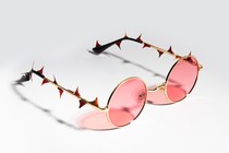 Photo illustration of rose colored glasses with thorns on them