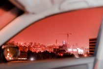Red-tinted Beirut captured through a car window