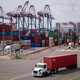 Trucks are loaded with shipping containers at the Port of Long Beach in Long Beach, California, on Thursday, March 6, 2025.