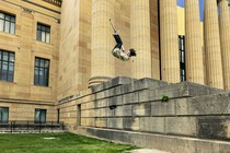 A man does a flip on a pogo stick.