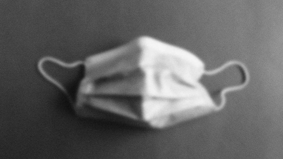 A fuzzy image of a surgical mask in gray scale