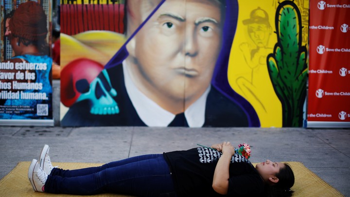A woman pays homage to undocumented migrants from El Salvador and their journey to the U.S.