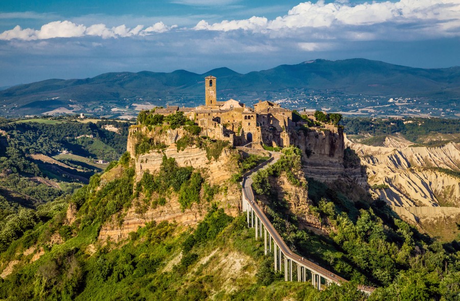 An ancient city sits on a rocky hilltop in central Italy.