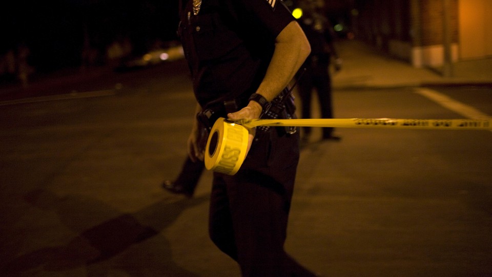 A police officer with caution tape.